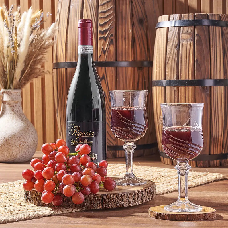 Red wine bottle, wine glasses, and grapes arranged for a corporate gift basket delivery in the Providence metro region.