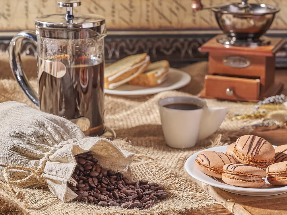 Prepared gourmet gift basket arrangement with coffee, macarons, and treats for special occasions.
